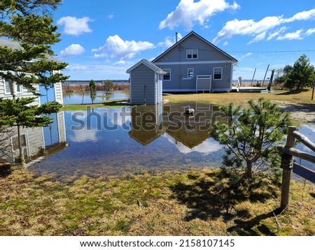 A large yard that has been flooded  water. Royalty-Free Stock Photo #2158107145