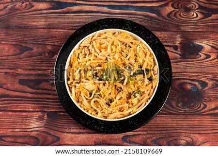 Traditional Spicy chow mein in a bowl isolated on marble background top view of chinese noodles