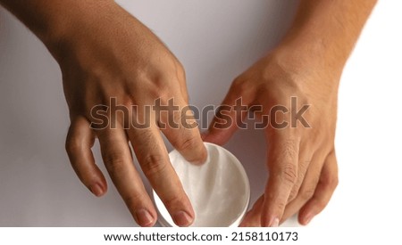 man applying cream on their hands