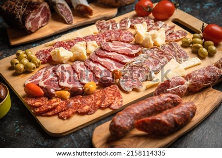 Charcuterie board with various cured meats and sausages Royalty-Free Stock Photo #2158114335