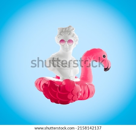 Collage of female head statuette with  inflatable flamingo and  pink glasses on  blue background. Summer travel poster concept. Royalty-Free Stock Photo #2158142137