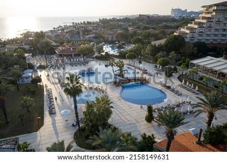 Aerial view of resort hotel with swimming pools. Tourists enjoying vacation at luxury hotel. Paradise all inclusive resort.