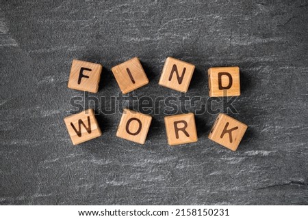 wooden block cubes with Find work words on grey background.