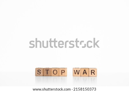 row of wooden cubes with words stop war isolated on white