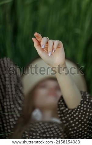 a girl's hand in the spring green grass