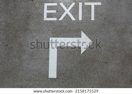 Asphalt road sign indicating direction