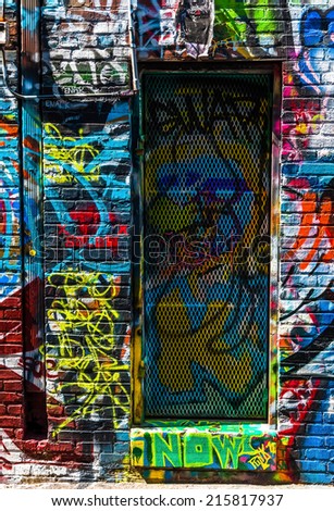 Graffiti on walls and door in Graffiti Alley, Baltimore, Maryland.