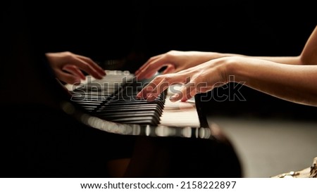 hands of a person playing piano	 Royalty-Free Stock Photo #2158222897