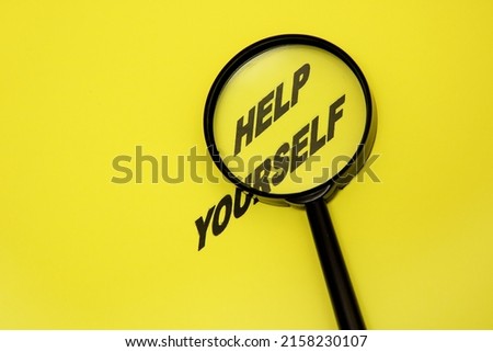 phrase help yourself is written on a yellow background, the words help yourself are magnified with a magnifying glass, psychology, self-development Royalty-Free Stock Photo #2158230107
