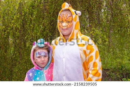 Children in kugurumi. Girls in bright, stylish, plush costumes with a beautiful, bright, themed face makeup.