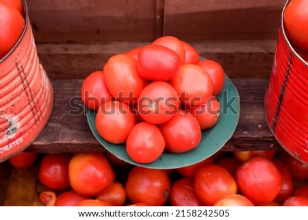fresh tomatoes displayed for sale in a market