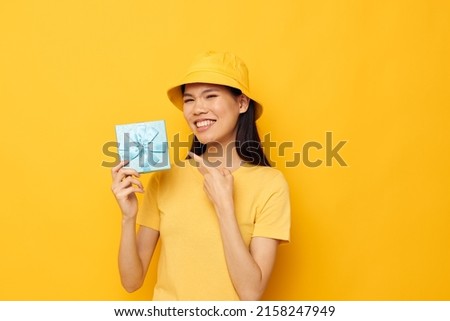 pretty brunette with a gift box in his hands surprise emotions isolated background unaltered
