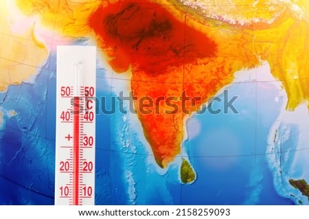 Thermometer with a record high temperature of fifty degrees Celsius, against the backdrop of the continent of the Indostan subcontinent. Hot weather concept Royalty-Free Stock Photo #2158259093