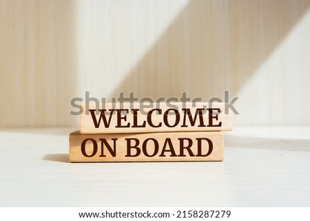 Wooden blocks with words 'Welcome on board'.