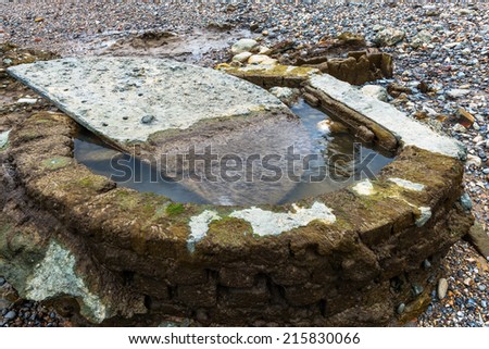 Old stone structure seen  on  Thames beach during a low tide, London, UK