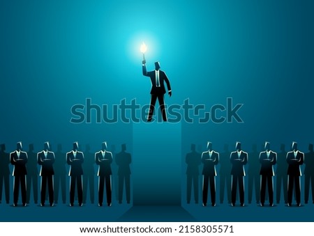 Businessman lighting up other businessmen with a torch on stage, leadership concept