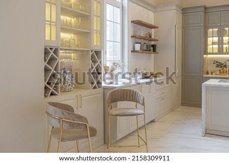 the latest fashion home trends in an ultra modern elegant interior of a cozy studio in soft pastel colors. close-ups of a stylish kitchen with an island for cooking