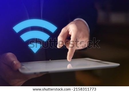 Man using tablet connected to WiFi indoors, closeup