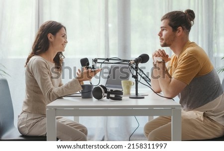Young professional speaker conducting a live podcast interview, communication and media concept
