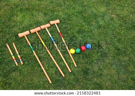 Set of croquet equipment on green grass, above view. Space for text Royalty-Free Stock Photo #2158322481