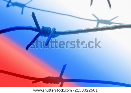 Barbed wire against russian flag as a symbol of totalitarianism and authoritarianism of russian. 