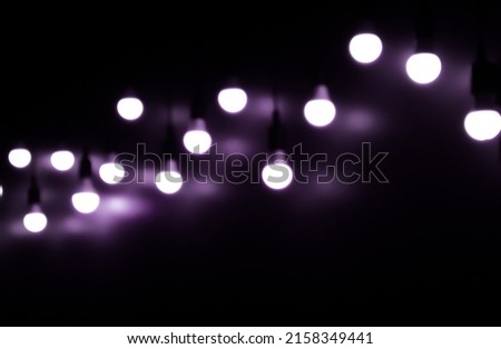 Open Light bulb on black background.add purple color