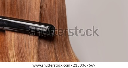 Keratin recovery hair and protein treatment with professional iron tool. Concept straighten spa and hair care on banner background