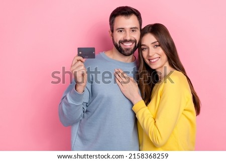 Photo of attractive lady handsome guy hug showing plastic debit card isolated on pink color background