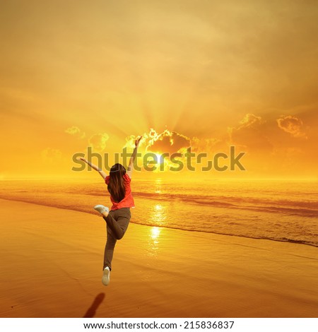 Happy Woman Jumping on Beach Sunset