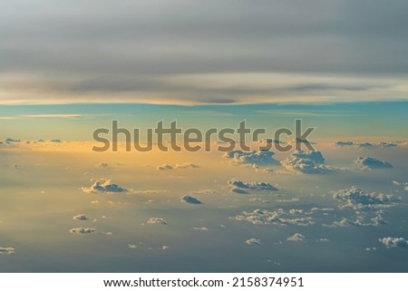 View over the clouds above Tanzania. Bright skyscape on sunset