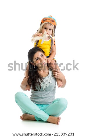 kid boy plays pilot sitting on mother shoulders
