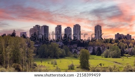 View of Residential Apartment Home Buildings in Metrotown. Green Trees in Deer Lake Park, Burnaby, Vancouver, BC, Canada. Sunset Sky Art Render