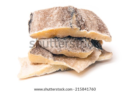 Pieces of salt cod fish isolated on a white studio background.
