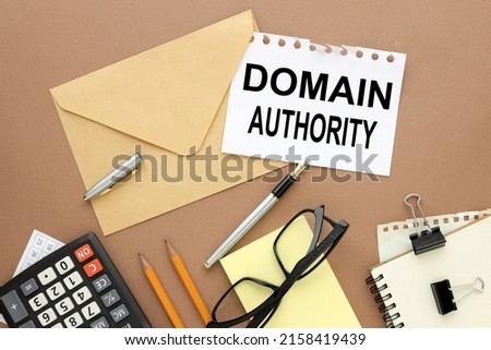 domain authority. written on envelope paper, on a wooden table with glasses, and yellow stickers. Top view conceptual.