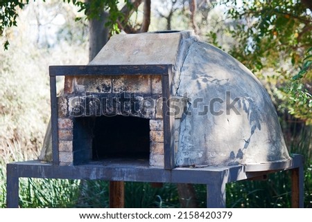 OUTDOORS PIZZA OVEN UNDER A TREE