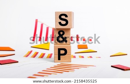 SP 500 index decline. Economic recession and crisis concept. Cubes with Standard and Poor abbreviation and charts showing shares dropping. Investment and trade concept. High quality photo