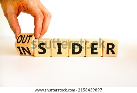 Insider or outsider symbol. Businessman turns wooden cubes and changes the concept word Insider to Outsider. Beautiful white table white background. Business insider or outsider concept. Copy space. Royalty-Free Stock Photo #2158439897