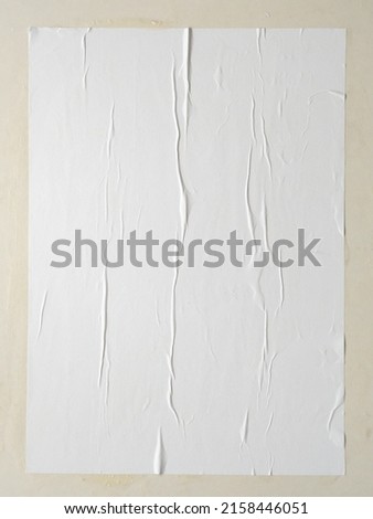 Blank white wheatpaste glued paper poster mockup on white wall background Royalty-Free Stock Photo #2158446051