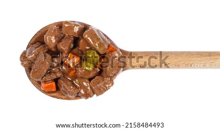 Wet complete food for adult dog with meat and vegetables in wooden spoon isolated on white, top view Royalty-Free Stock Photo #2158484493