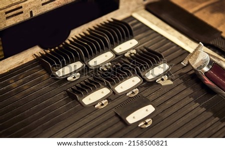 Barber shops tools. Accessories for cutting on the table in a barbershop. Comb, brush, scissors, clipper and nozzles.