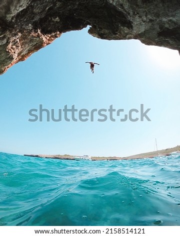 A photo of cliff diving and clear sunny sky