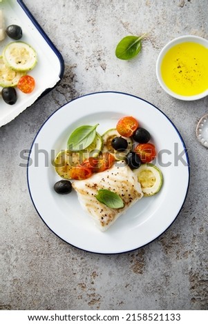 Roasted cod with olives and tomatoes