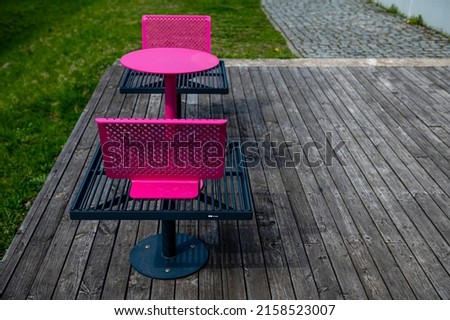 colorful metal benches and tables on the terrace on a sunny day