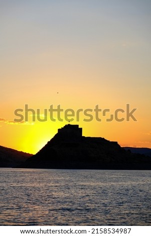 Sunset view of the impressive castle on the dam from Tunceli, Turkey. Its real name in Turkey is "Pertek Kalesi".
