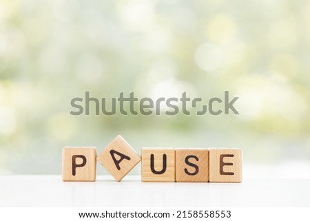 Wooden Blocks with the text: Pause on a green background Royalty-Free Stock Photo #2158558553
