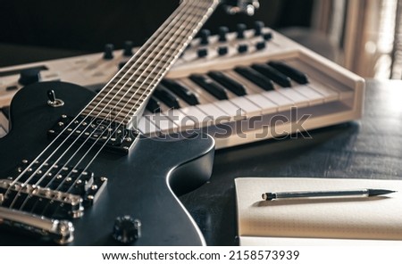 Close-up, electric guitar and piano, the concept of musical creativity, modern musical instruments. Royalty-Free Stock Photo #2158573939