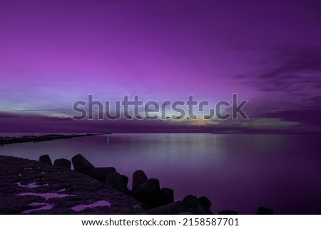 A seascape under a purple beautiful sky