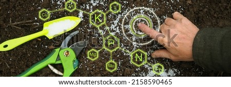 Farmer hand touch Green technologies agriculture digital mineral nutrients icon. Potassium nitrogen Organic fertilizers, garden tools soil. Smart Solve Fertilizer Crisis. Top view Future agriculture Royalty-Free Stock Photo #2158590465