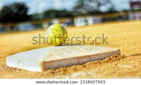 A closeup of a dirty softball ball