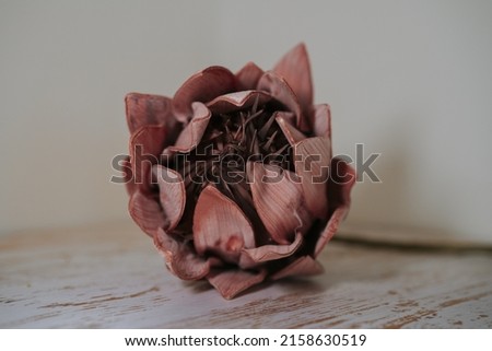 A closeup of a flower brooch made of leather